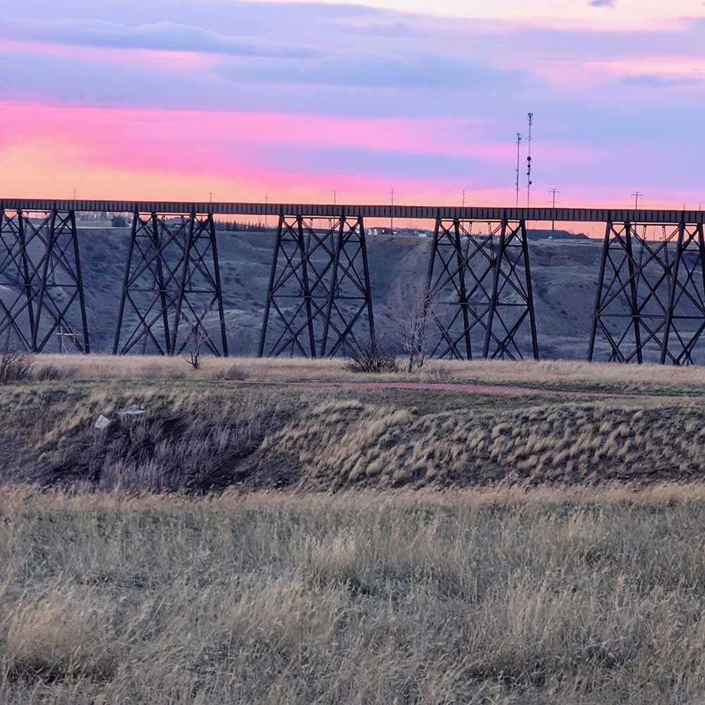 a sunset behind a bridge